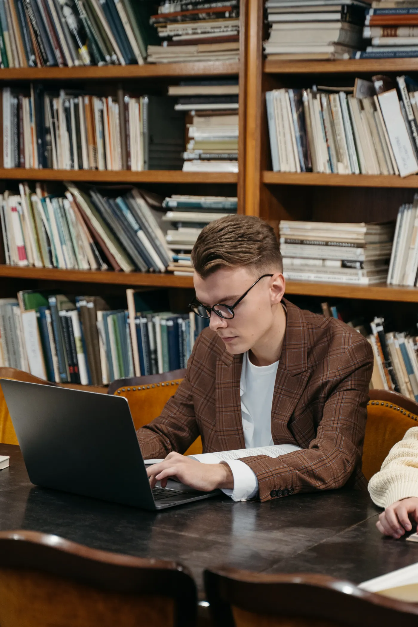 Person using a laptop in a public library